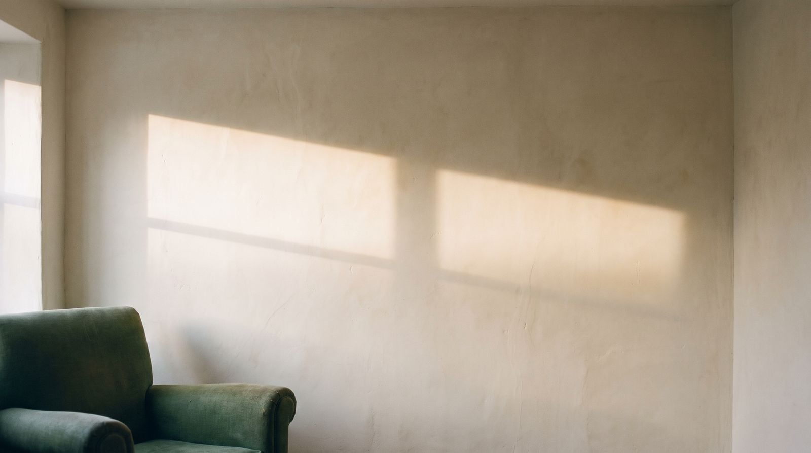 A band of afternoon light crossing a plaster wall.