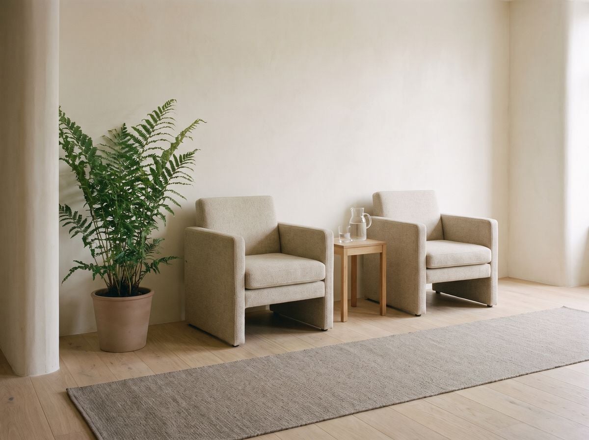 Two chairs and a side table in the waiting corner.